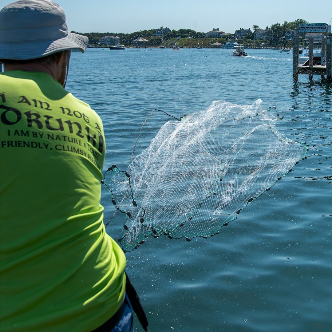 Croatian fisherman mending nets on a boat