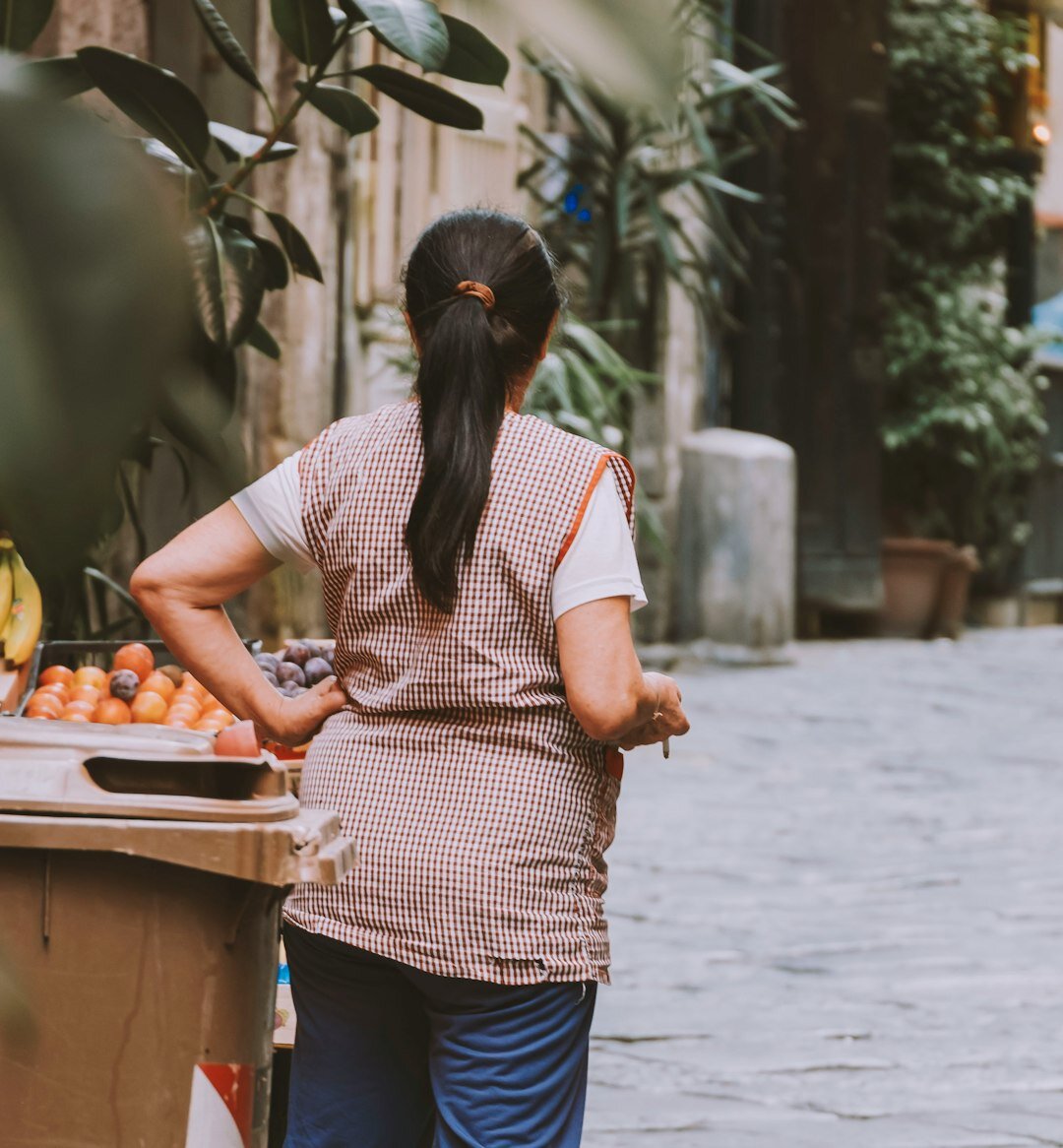 Croatian market vendor woman arranging vegetables